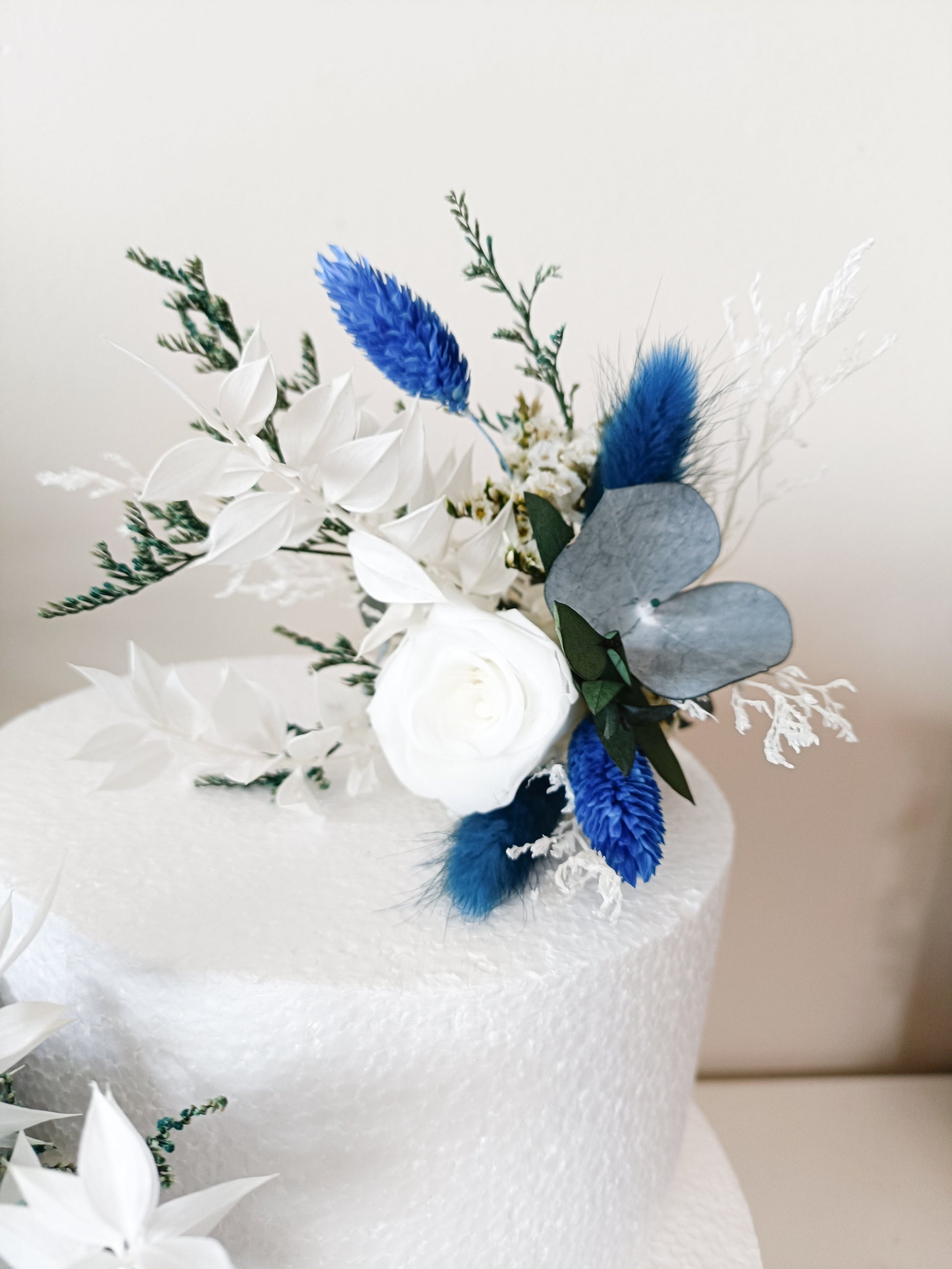 Top view of cake decorated with premium dried and artificial flowers for modern celebrations