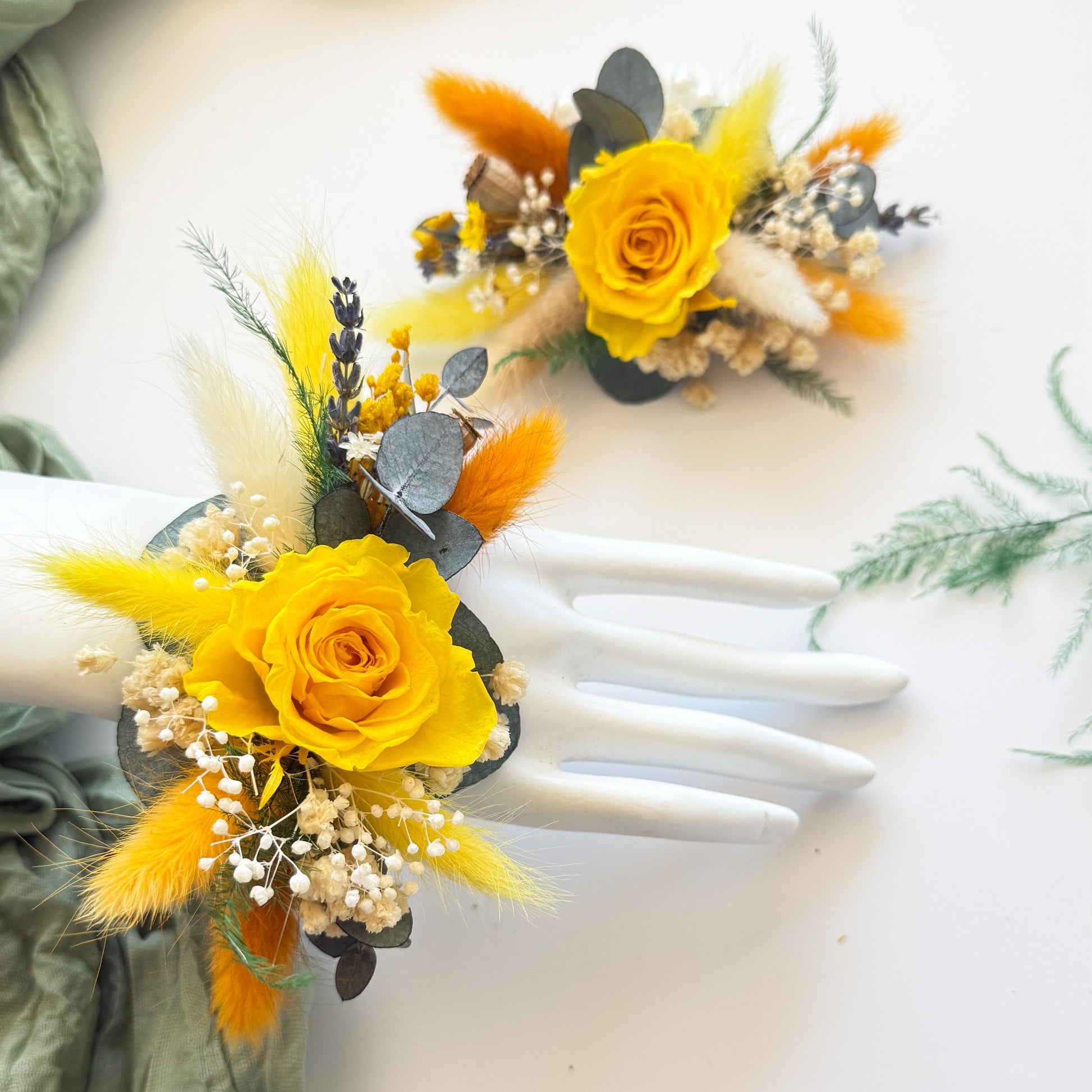 Yellow flower corsages on white gloves with green fabric background