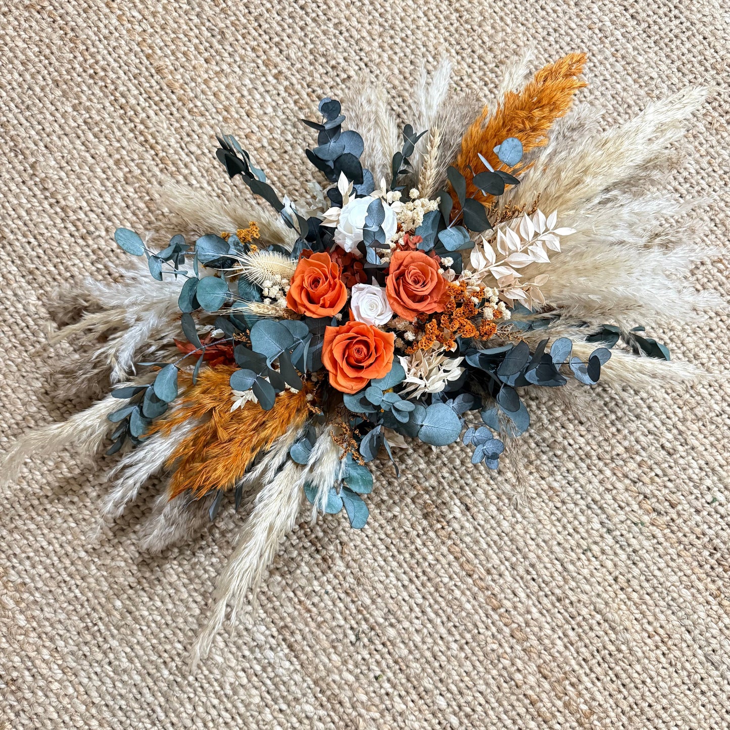 Arbor flowers arrangement with blue, orange and dried flowers for wedding arch decor