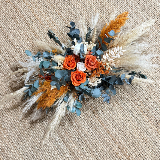 Arbor flowers arrangement with blue, orange and dried flowers for wedding arch decor