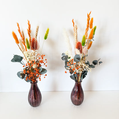 Flatlay of Australian dried flower arrangements in terracotta and orange shades with natural wheat and preserved eucalyptus