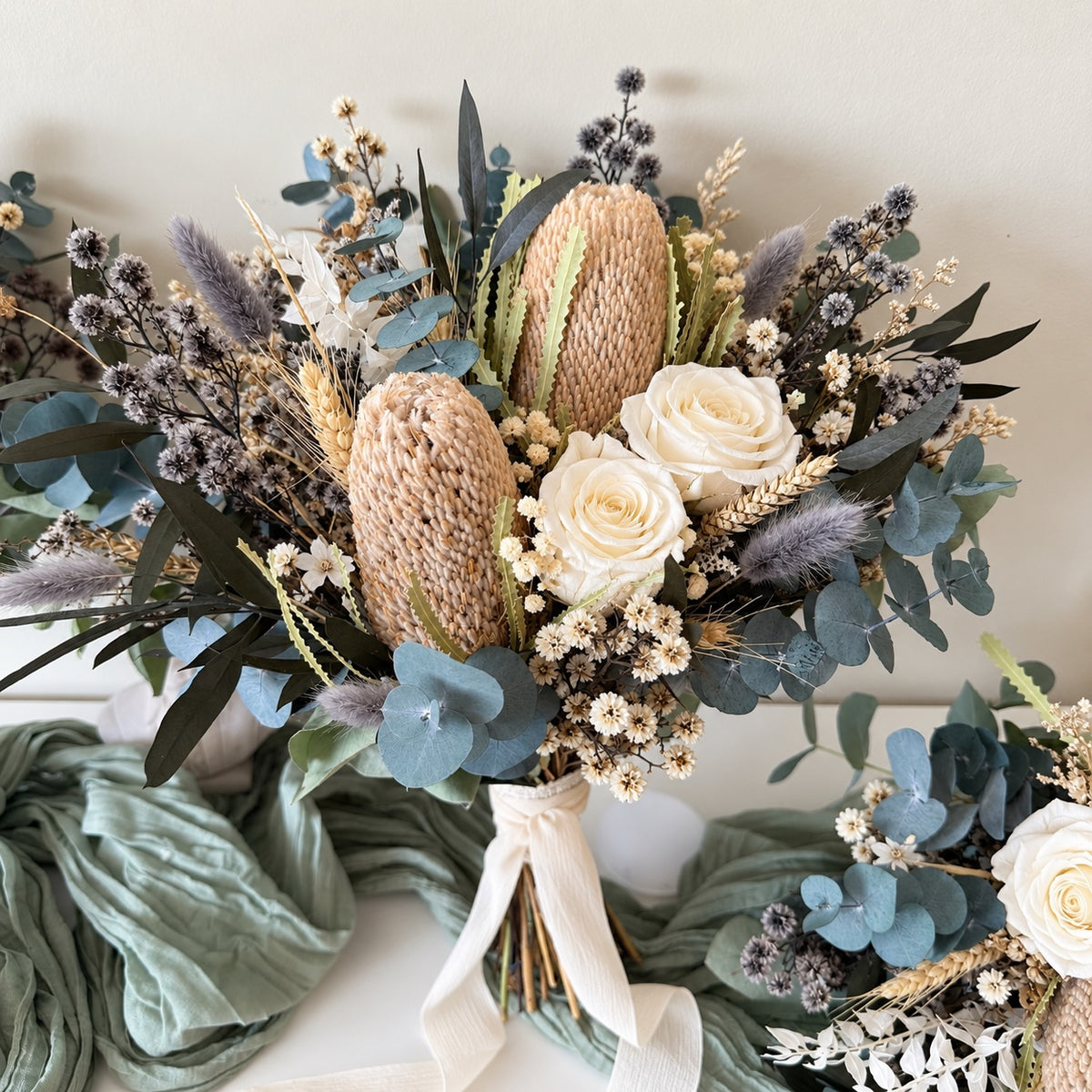 Australian native dried wedding bouquet with Banksia, preserved eucalyptus, ivory roses and neutral dried flowers