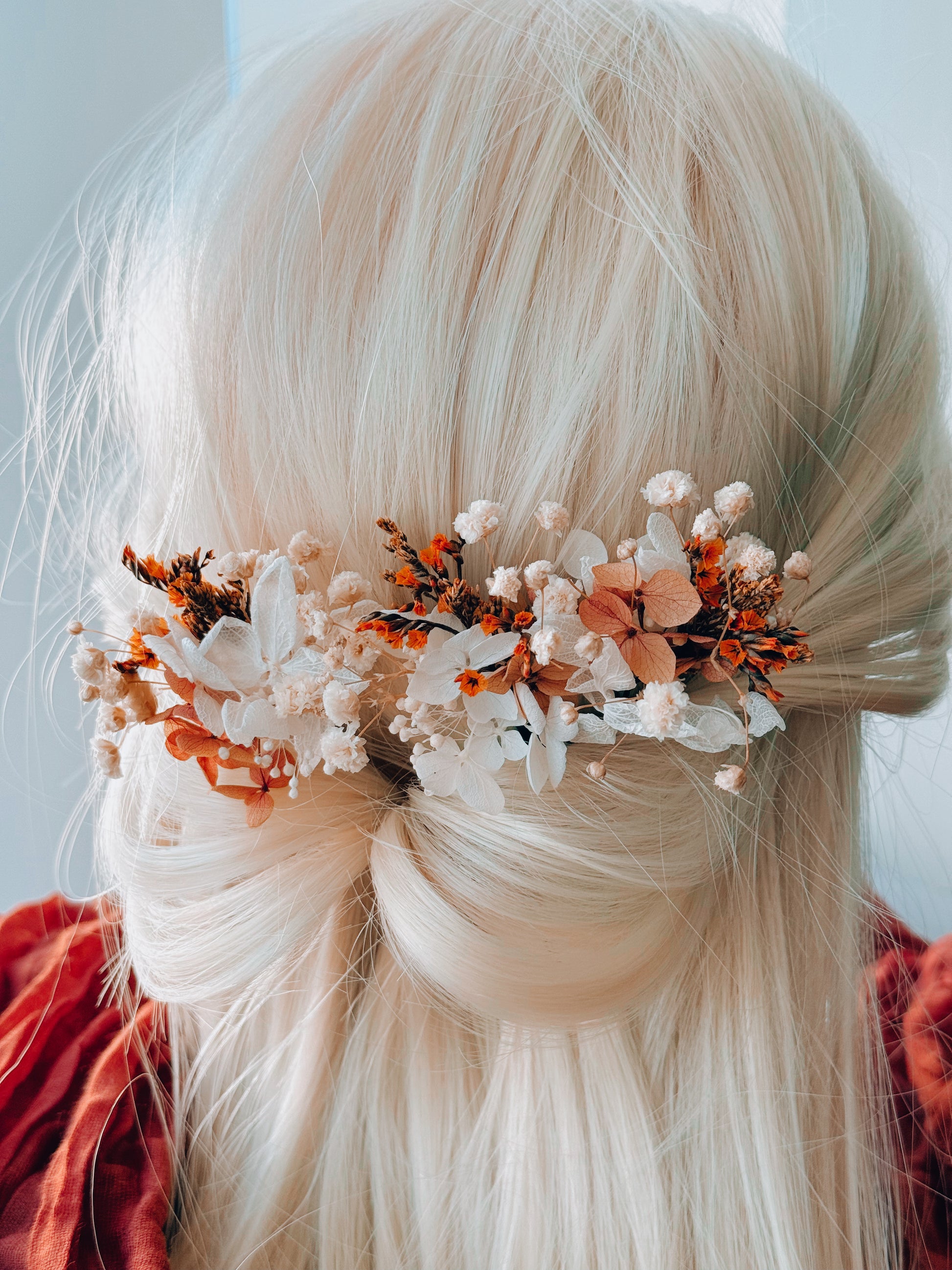 Australian wedding bridal hairpiece made with dried flowers in burnt orange, ivory and beige tones, styled for a soft boho bridal look