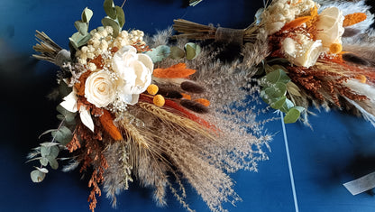 Stunning wedding bouquet made of dried flowers, featuring rustic hues of orange, beige, and green. This handcrafted arrangement includes preserved roses, eucalyptus, pampas grass, and other textural elements, perfect for a boho-chic wedding. Available for custom orders