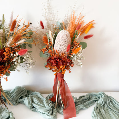 Handcrafted wedding bouquets with preserved banksia, bunny tails, and terracotta accents on white background