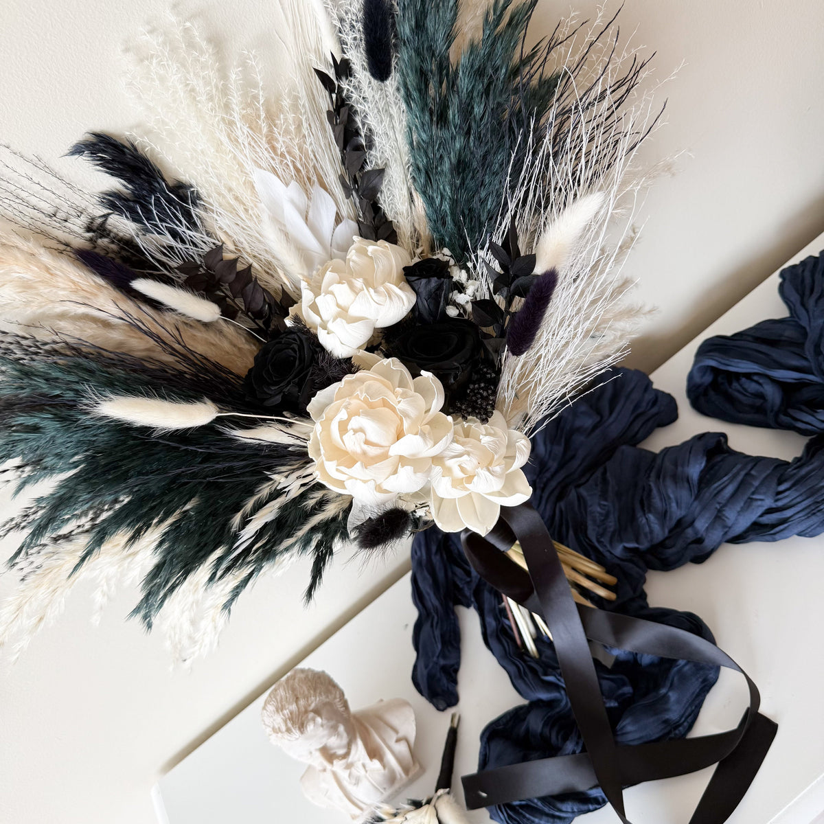 Black and ivory preserved bridal bouquet with dried flowers, roses and textured foliage