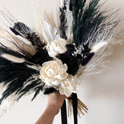 Hand held black and white preserved wedding bouquet with ivory roses and dried flowers