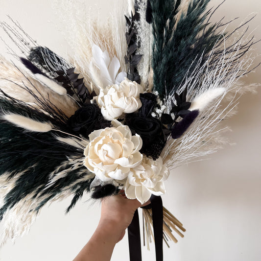 Hand held black and white preserved wedding bouquet with ivory roses and dried flowers