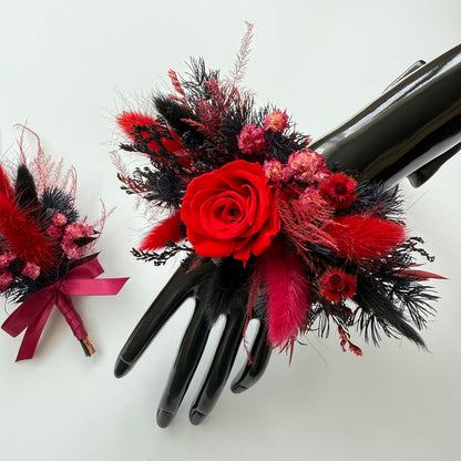 Black glove with red rose and pink flowers on a white background
