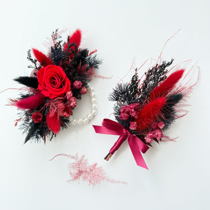Two floral accessories with red, black, and pink flowers on a white background