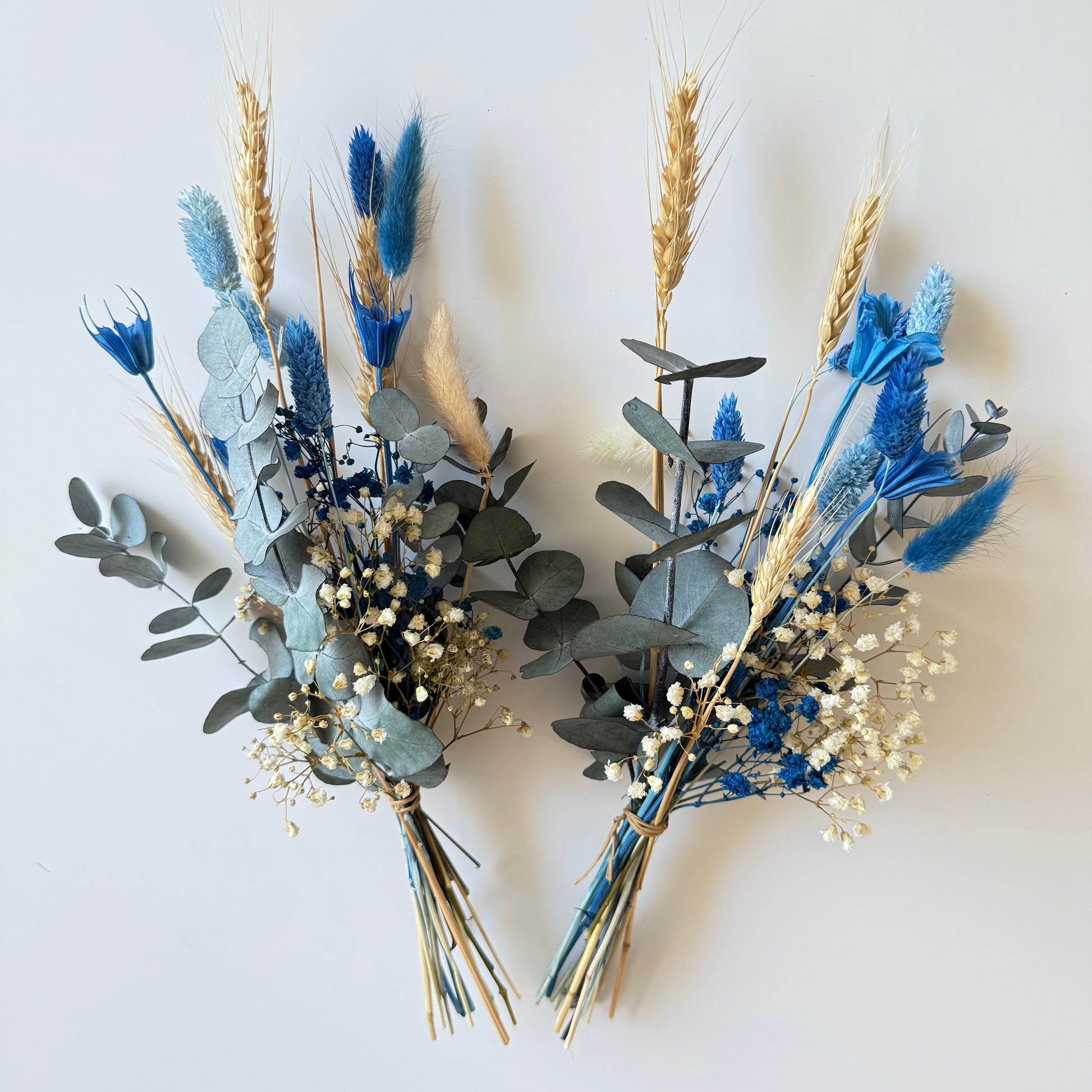 Pair of dried flower vase arrangements with blue, ivory, and yellow tones, perfect for wedding or home decoration.