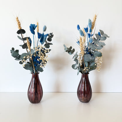 Blue and ivory dried flower bud vase arrangements with preserved eucalyptus and natural grasses for wedding table decor