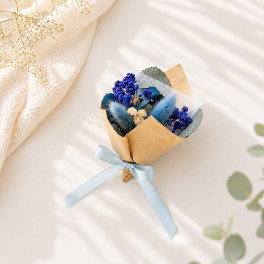 Mini blue dried flower bouquet with eucalyptus and light blue ribbon, wrapped in kraft paper for bridesmaid proposal or gift