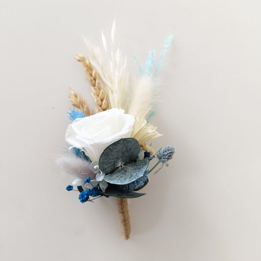 Boho blue dried flower boutonnieres for wedding party with preserved foliage and fluffy details