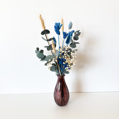 Vase with dried flowers on a white background