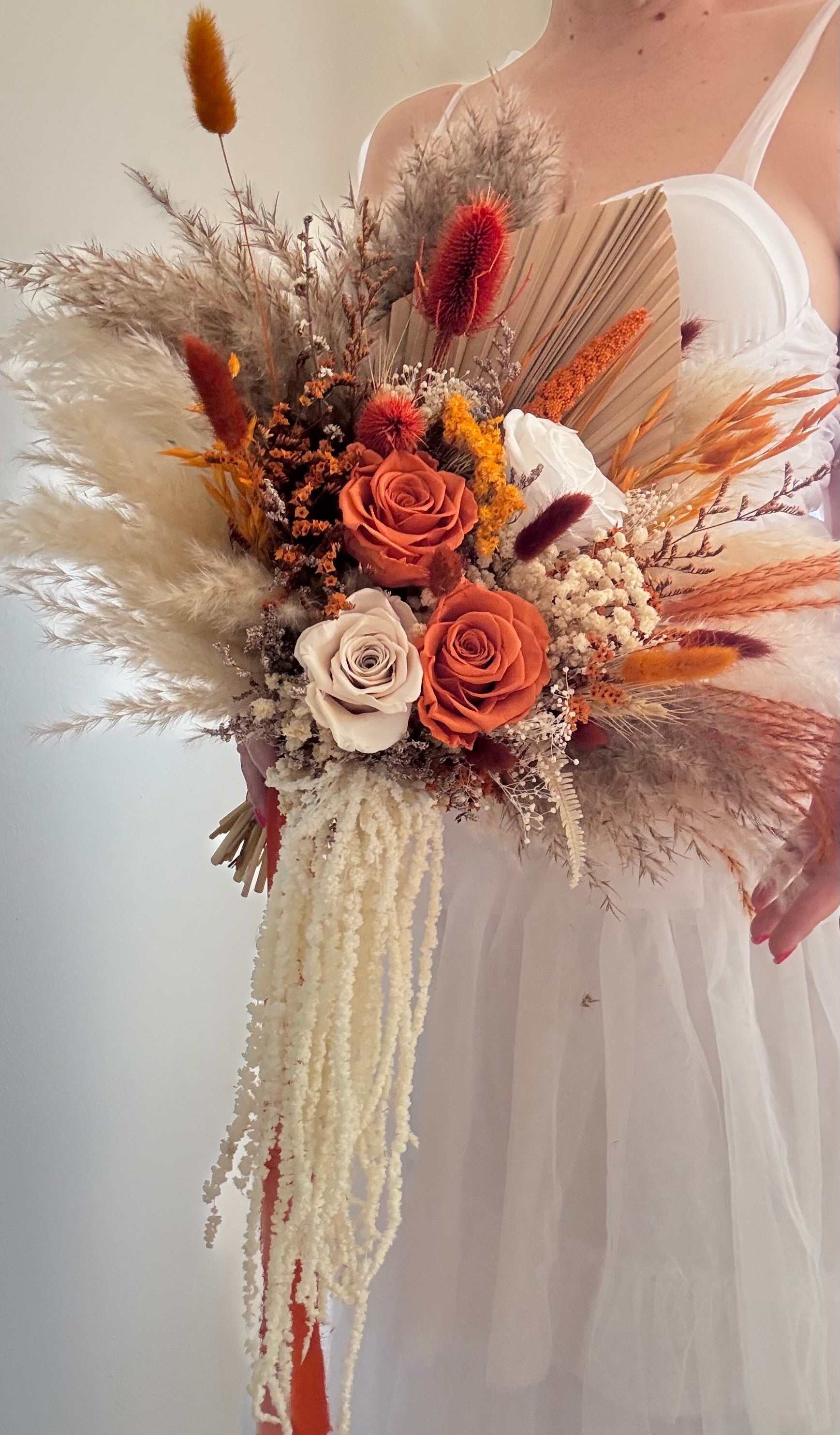 Full-length boho bridal bouquet with pampas grass and preserved roses