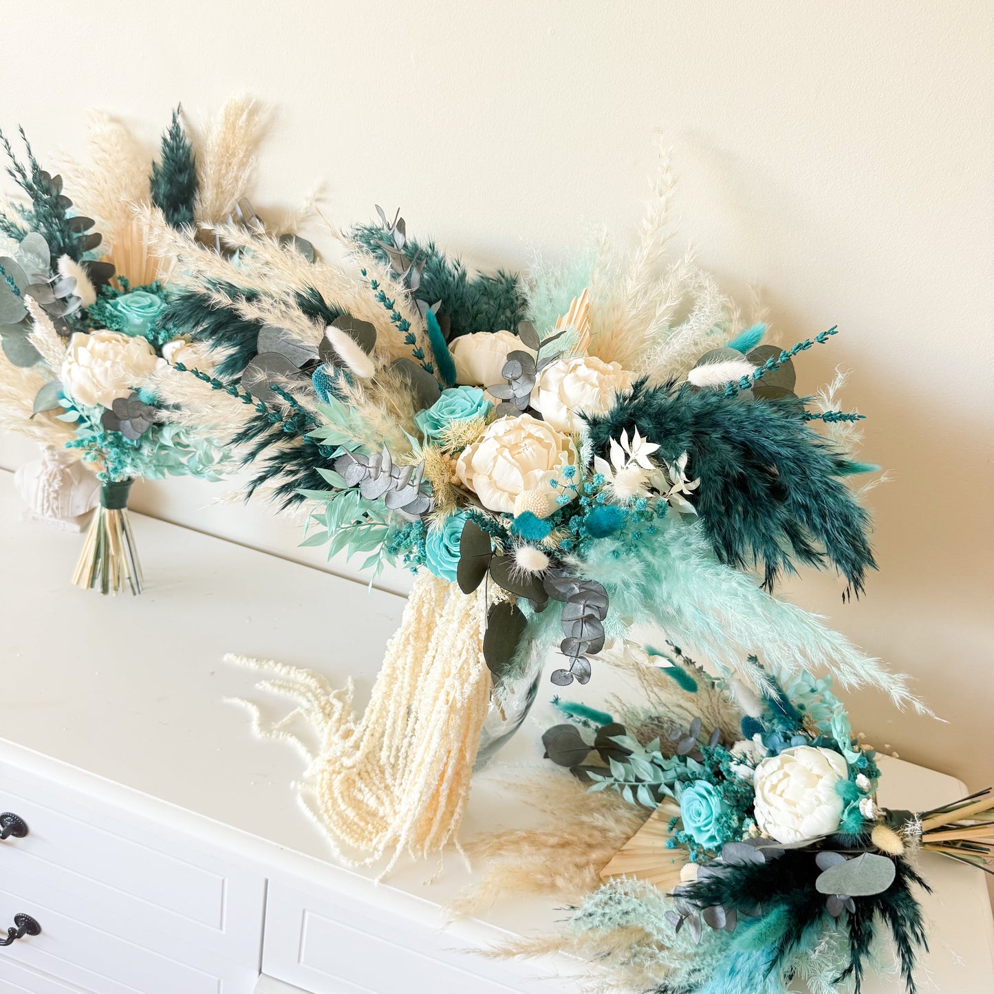 Boho bridal bouquet with pampas grass and teal floral arrangement