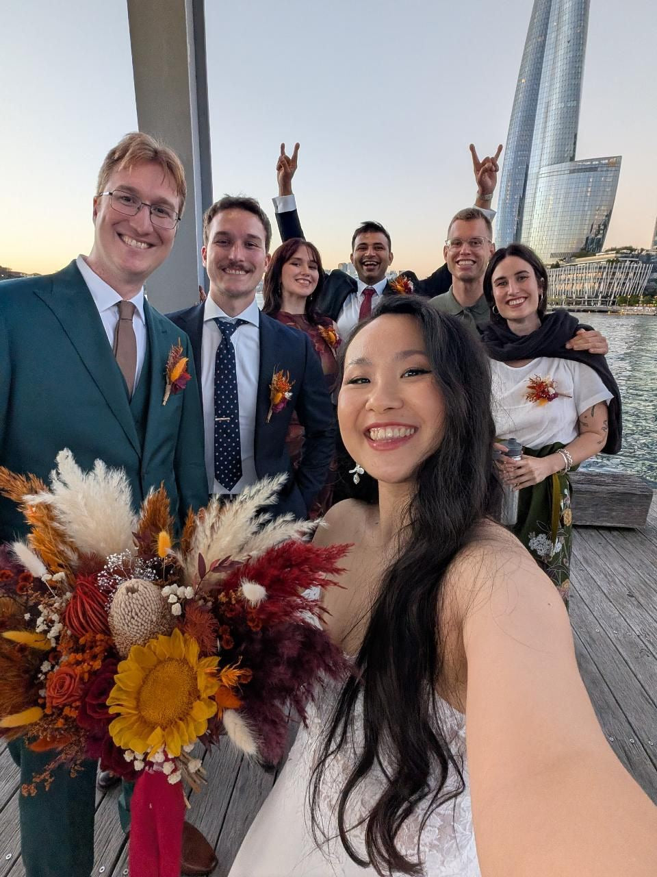 Bride with boho orange and burgundy bouquet