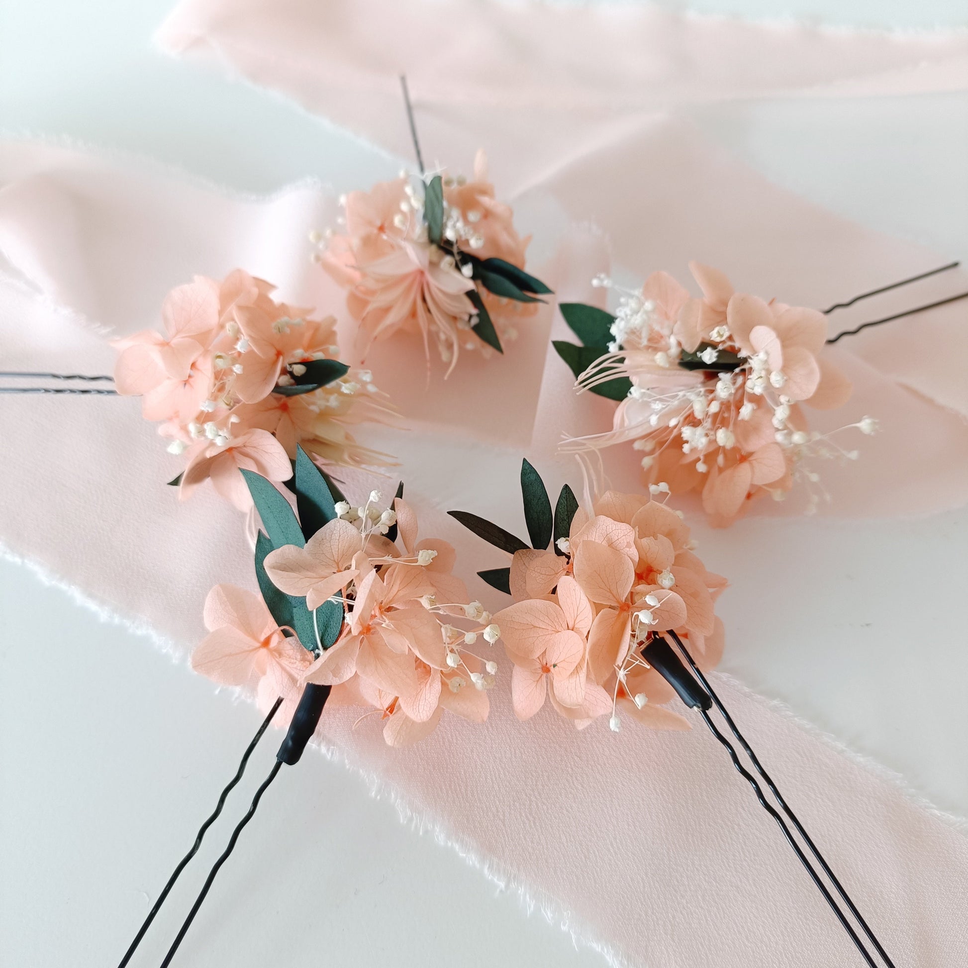 Handcrafted bridal hair accessories with blush hydrangea and baby's breath on bobby pins