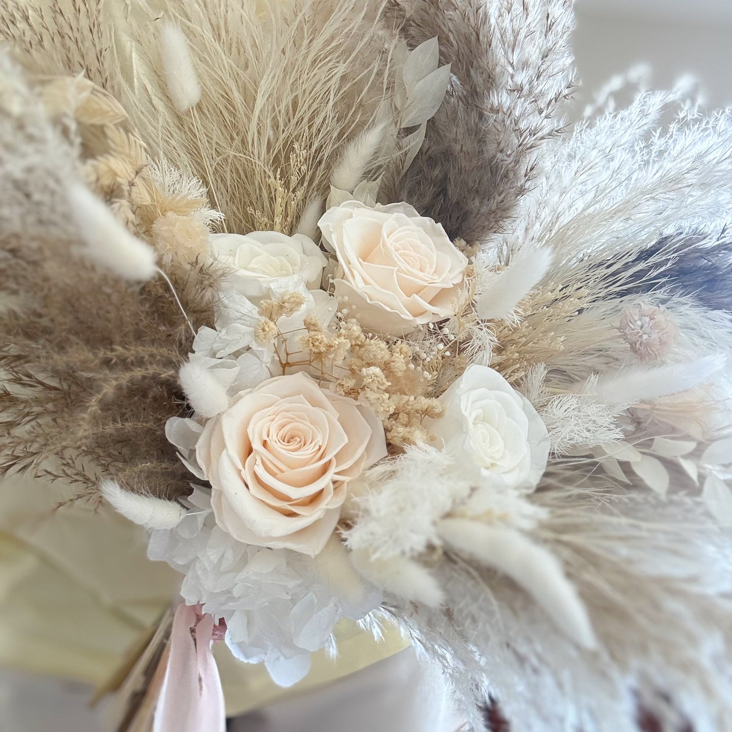 Bridal Boho Bouquet of flowers with pampas grass and roses on a blurred background