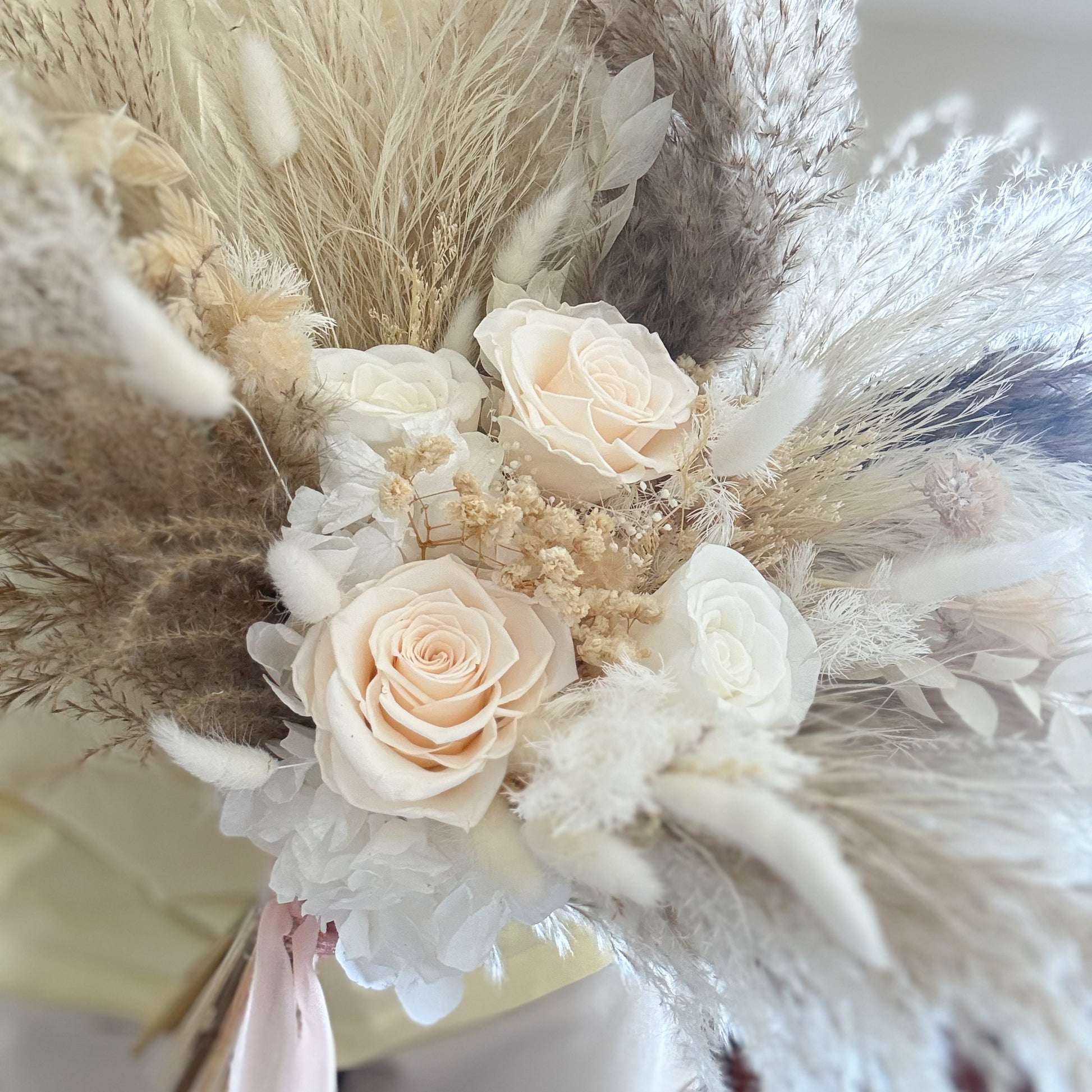 Bridal Boho Bouquet of flowers with pampas grass and roses on a blurred background