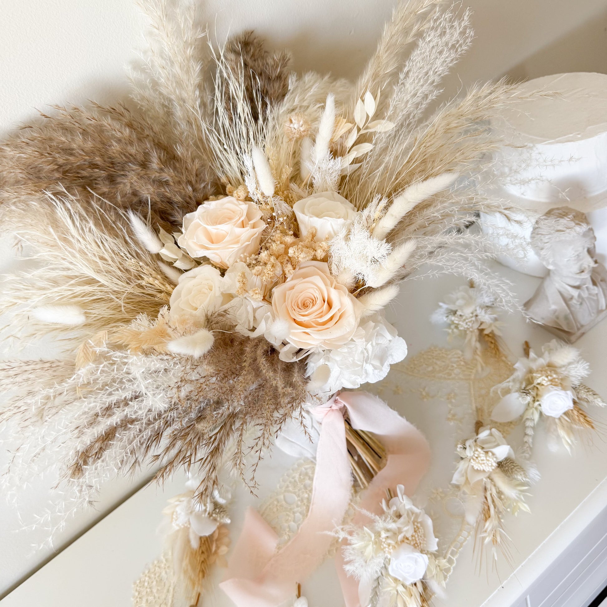 Side view of pampas grass dried flower bouquet with ivory roses