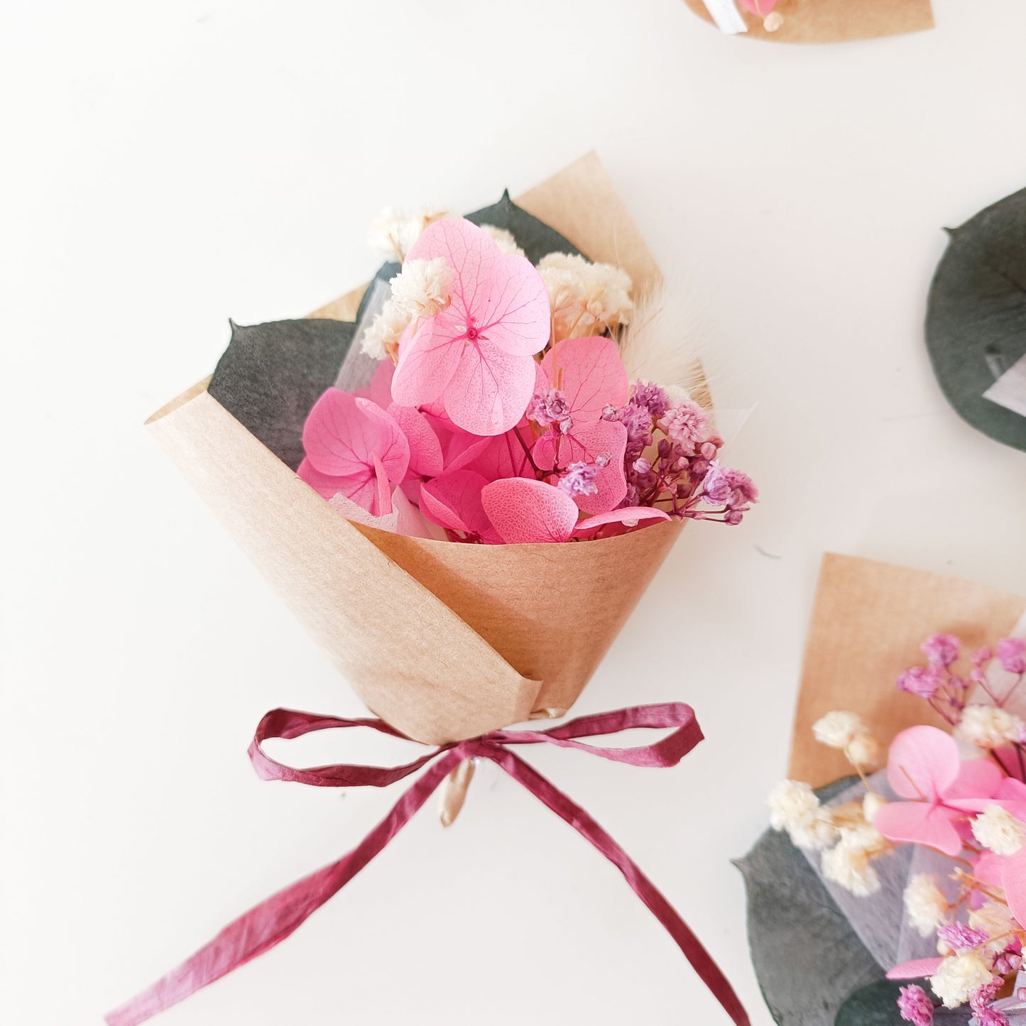 Pink dried flower favours tied with velvet ribbon, handcrafted for weddings, baby showers, and bridal parties.