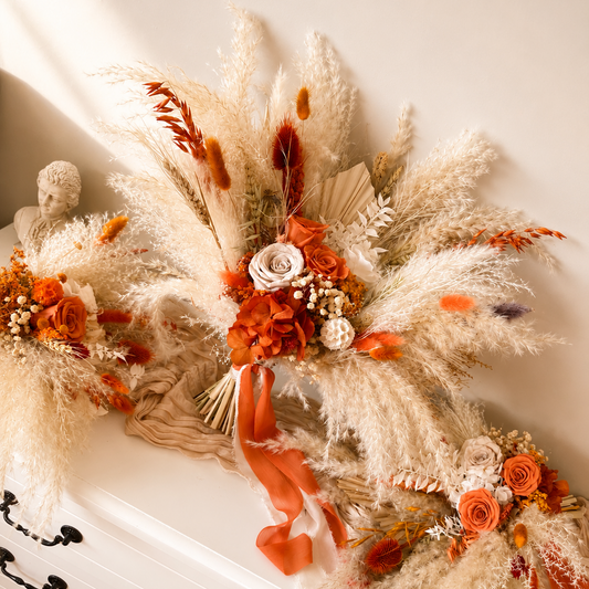 Boho wedding bouquet styled with neutral and burnt orange dried flowers