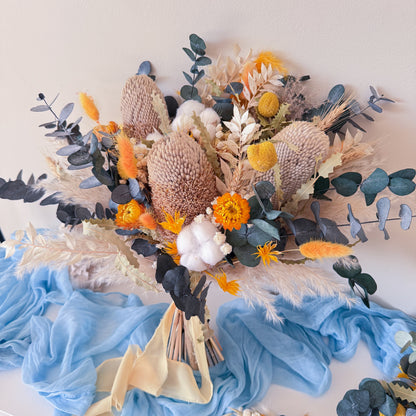 Boho wedding dried flower bouquet with blue eucalyptus, neutral tones and yellow accents