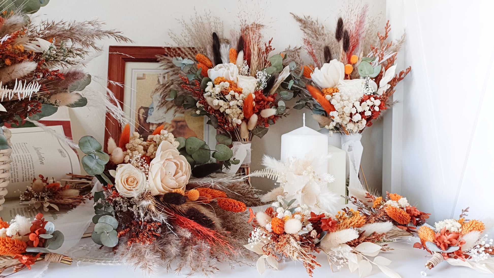 A curated selection of dried flower arrangements, including wedding bouquets and floral accessories in vibrant autumnal shades. Customizable for your special day