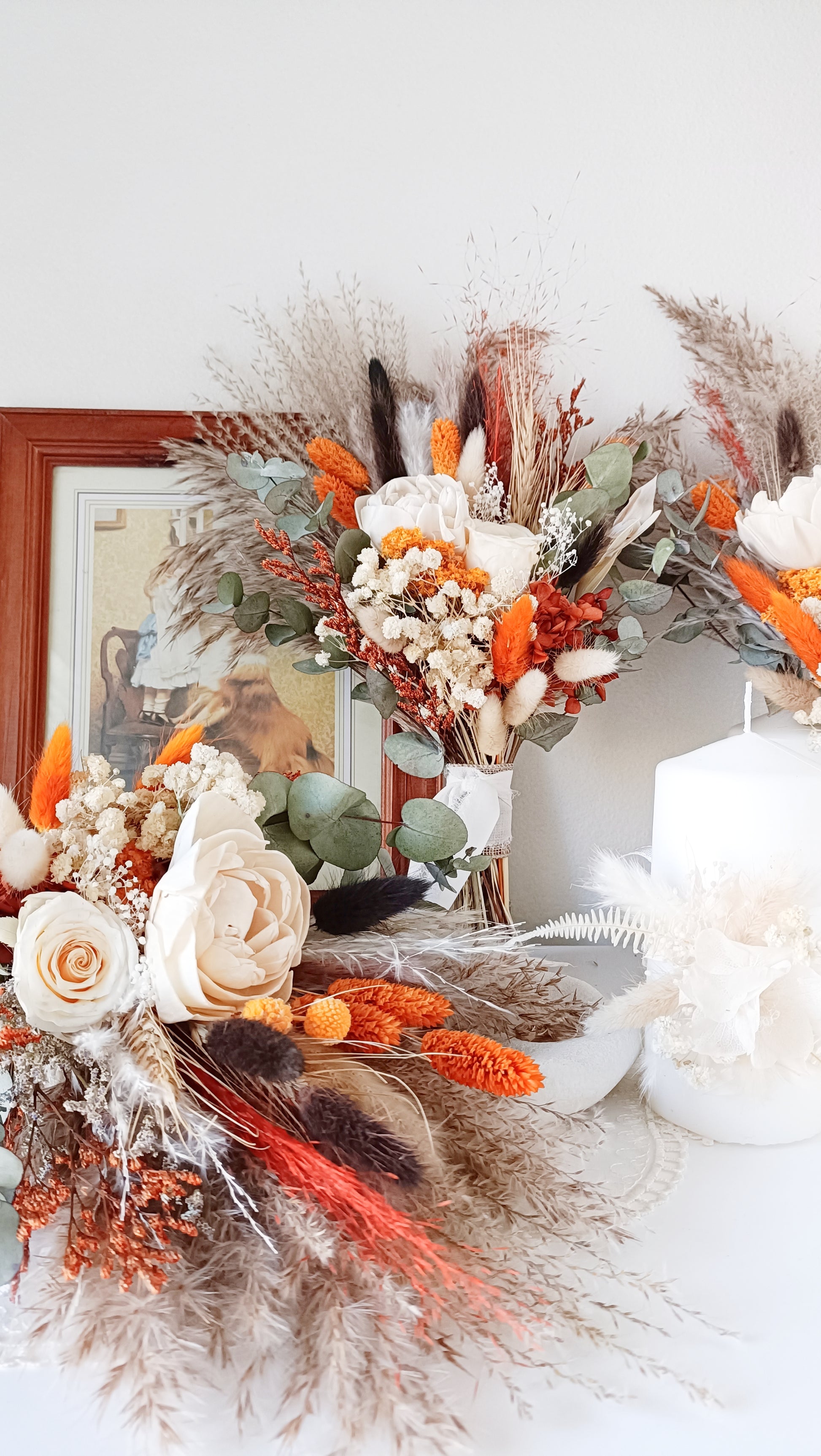 Bohemian-inspired wedding accessories, including dried flower bouquets and boutonnieres. These handcrafted pieces feature natural, warm tones and intricate details, ideal for outdoor weddings