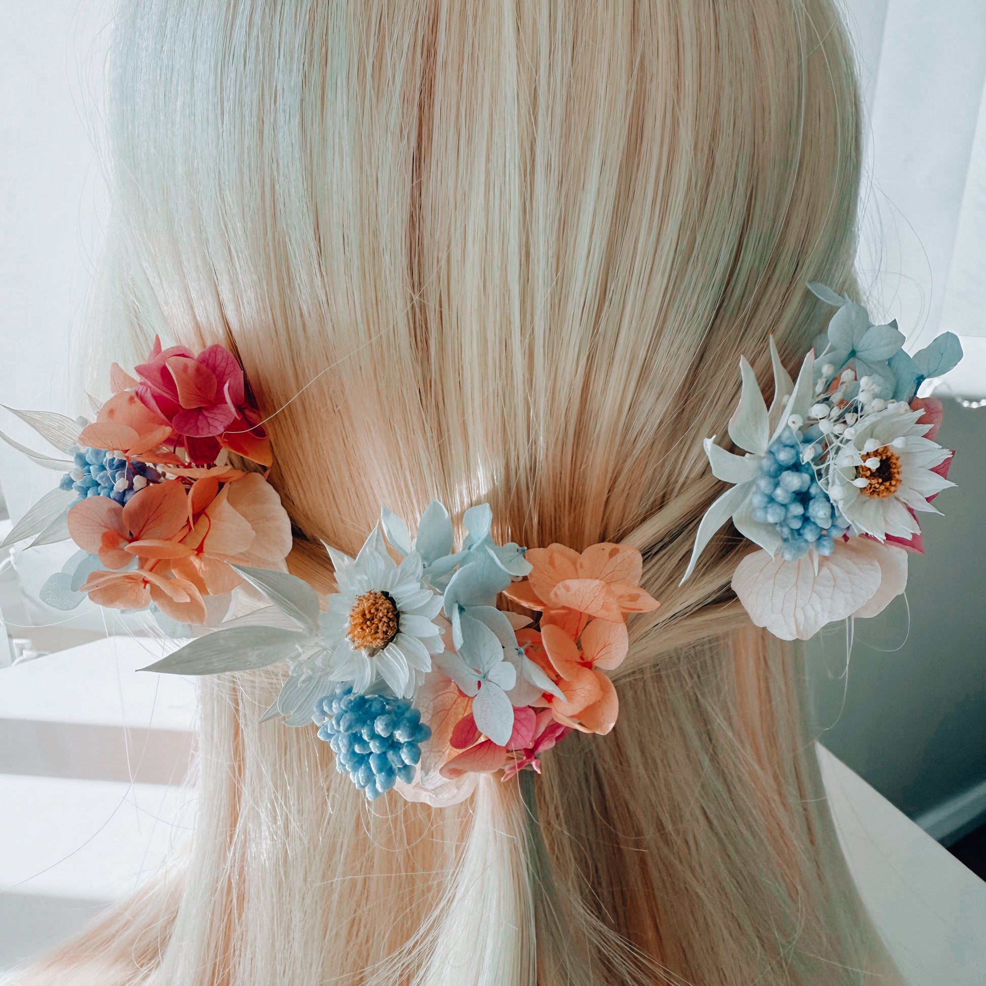 Boho bridal hairpiece with pastel flowers in peach, pink, and blue, romantic wedding hairstyle accessory