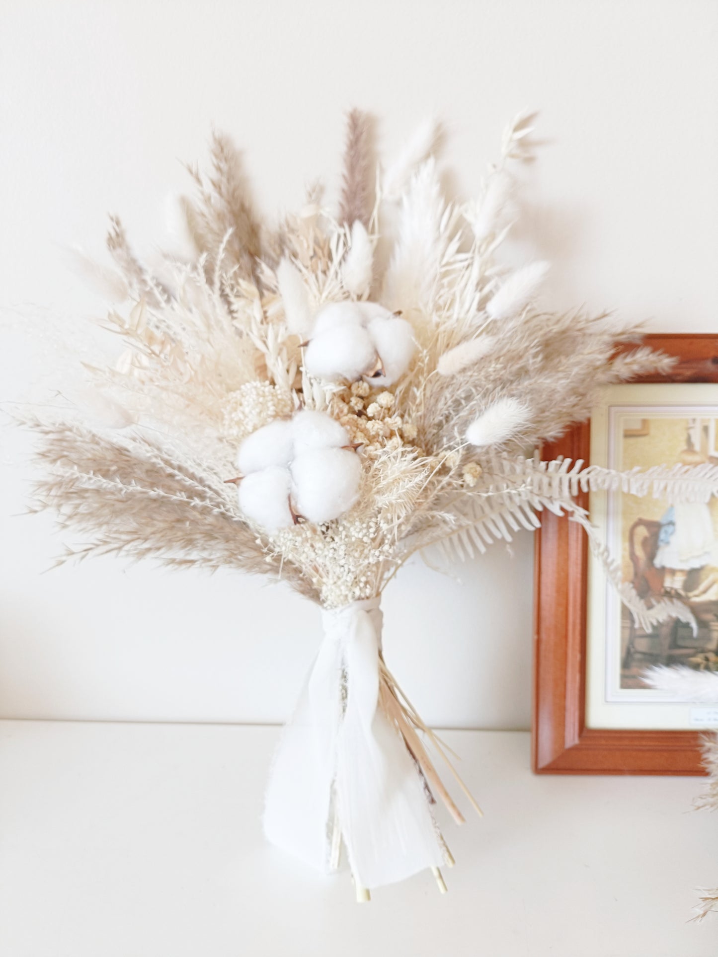 Beige and white dried flower bouquet for brides, crafted with pampas, sola wood flowers, and natural textures.