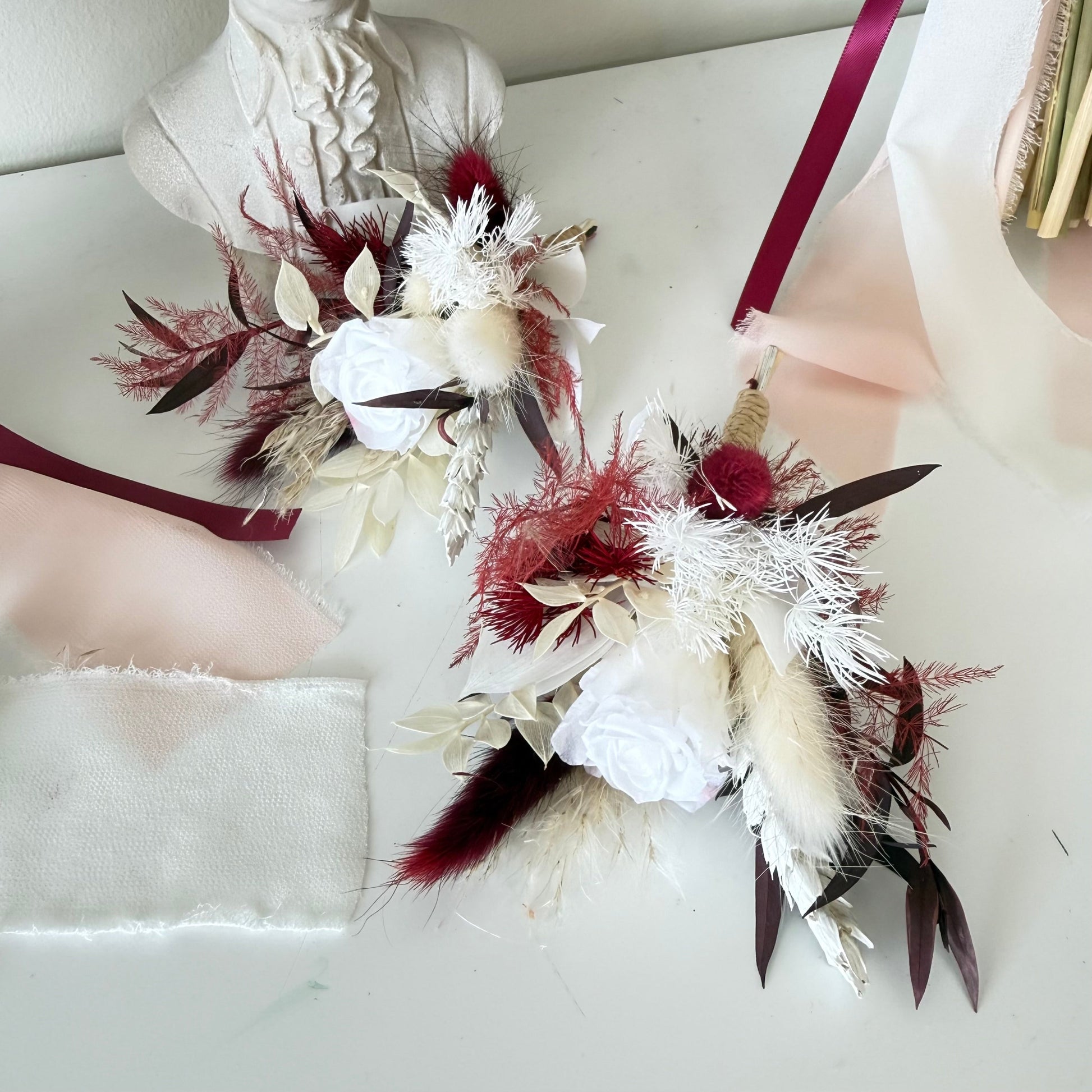 Decorative flower boutonnieres with red and white flowers 