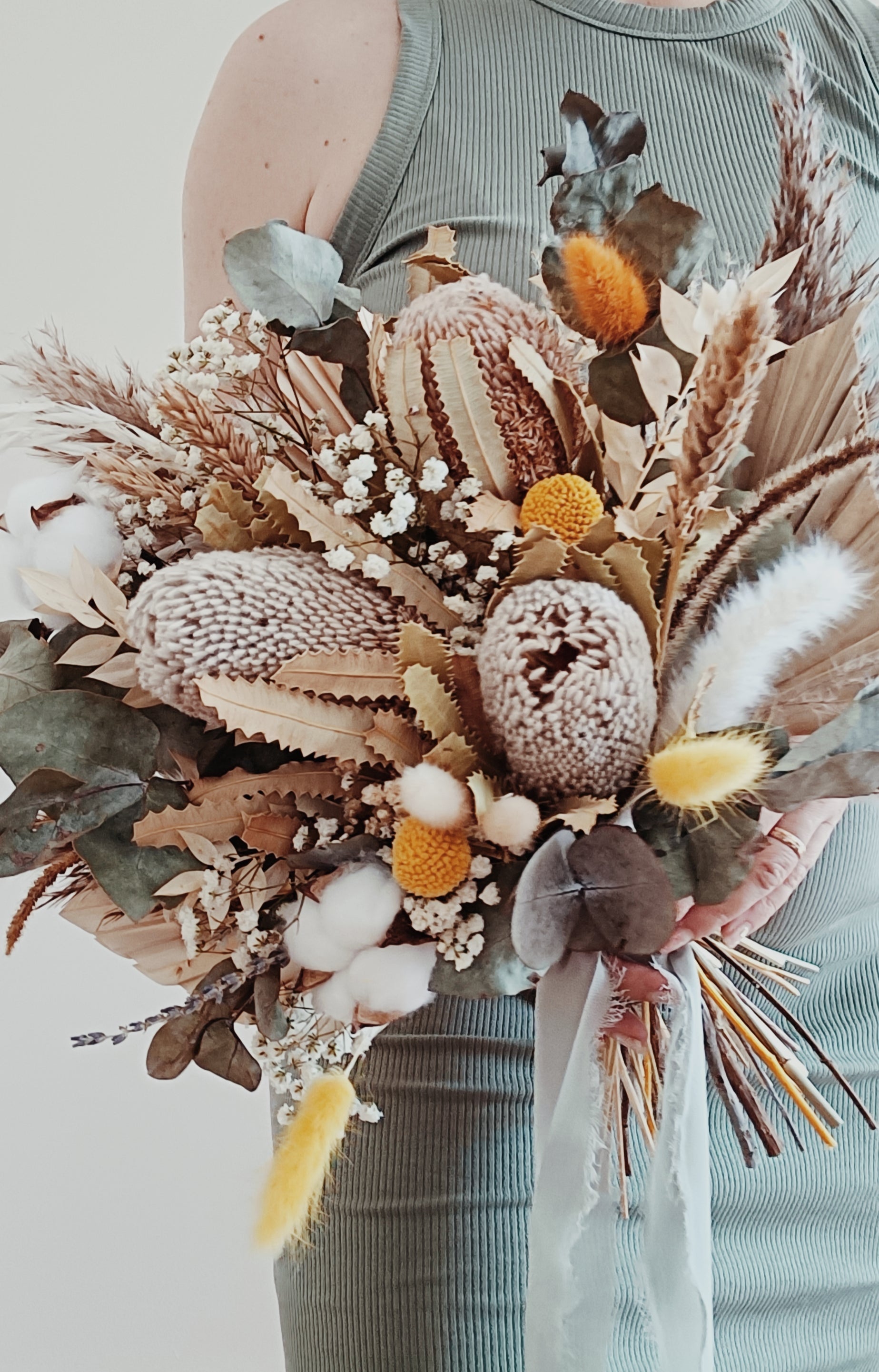 Textured bouquet of preserved flowers including palm leaves, banksia, bunny tails, and cotton – ideal for natural, relaxed wedding styles.