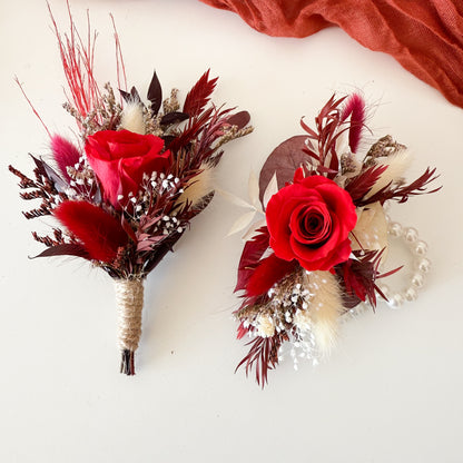 Groom and groomsmen dried flower boutonnieres with burgundy roses, pampas grass, and rustic accents.