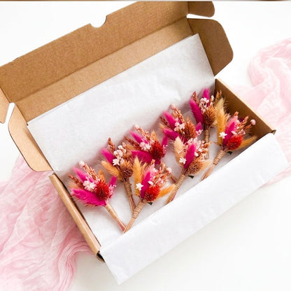 Set of pink dried flower boutonnieres presented in a gift box, preserved floral wedding favors for bridesmaids, guests and wedding party