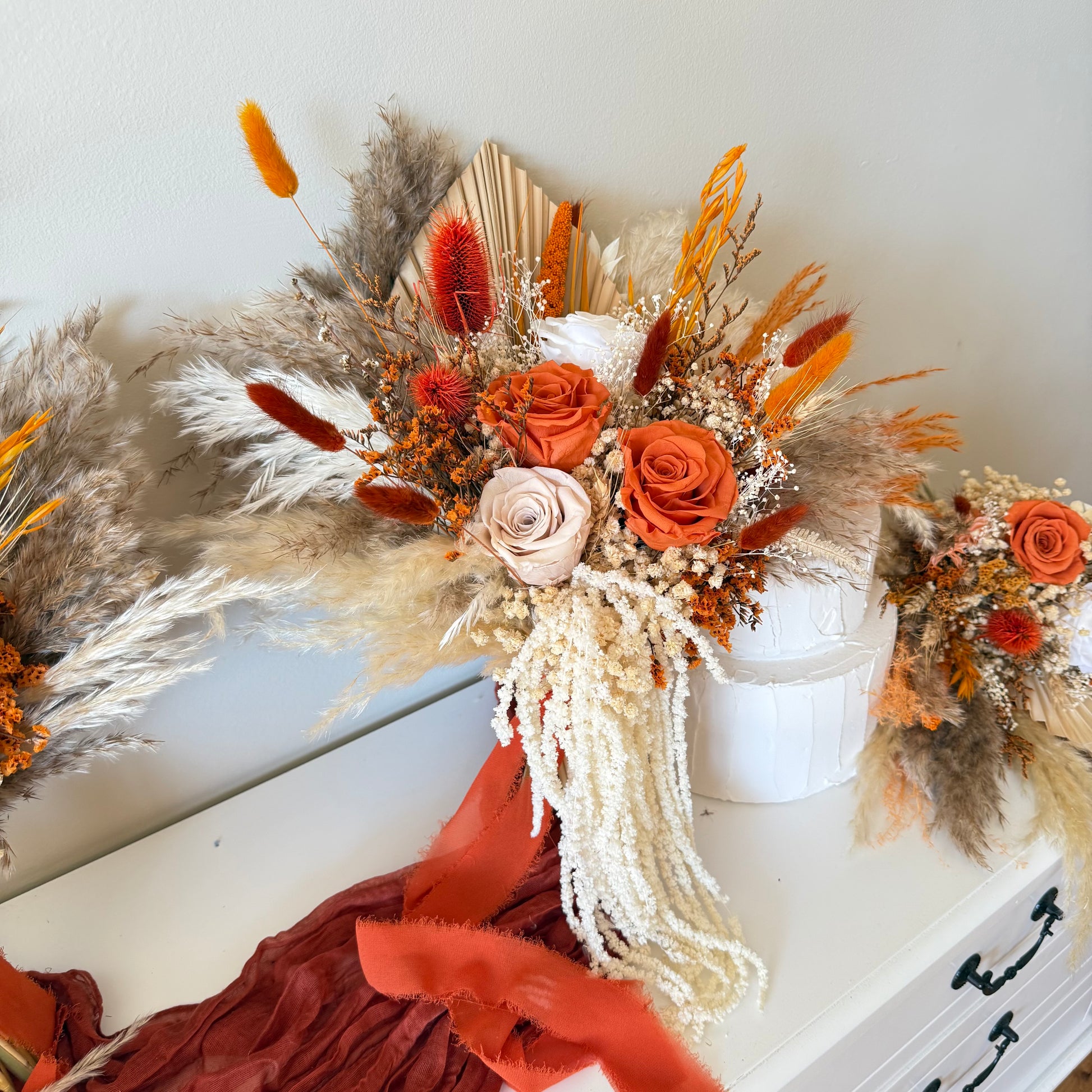Terracotta dried flower bouquet styled with matching wedding florals