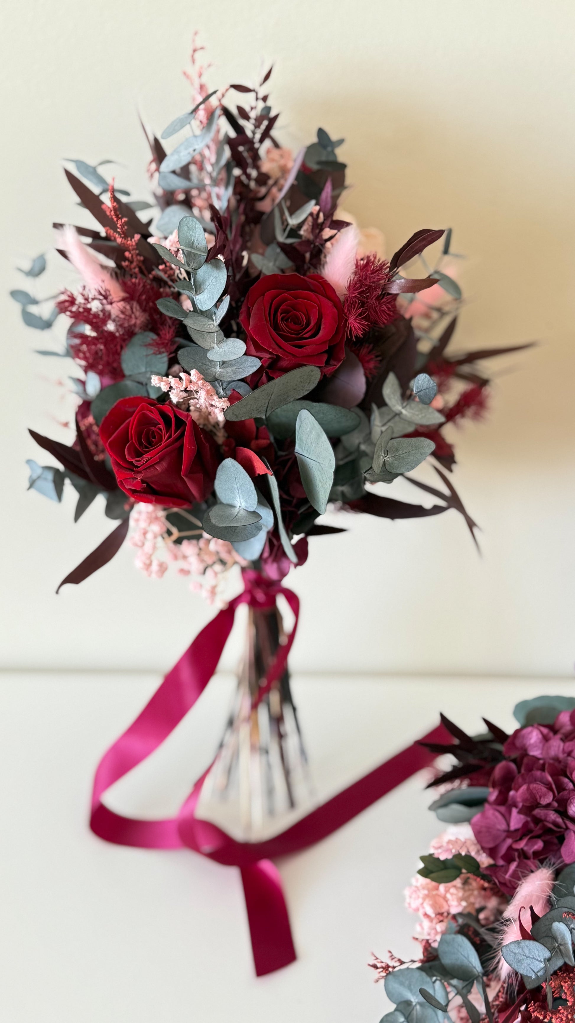Burgundy dried flower wedding bouquet and table arrangement with preserved flowers