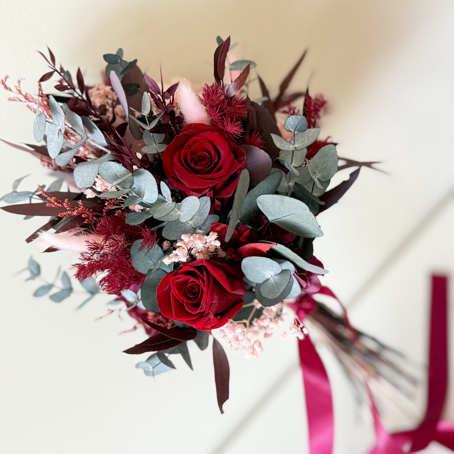 Burgundy dried flower wedding bouquet with preserved roses and eucalyptus