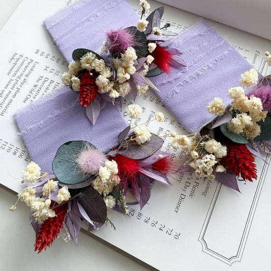 Burgundy and lilac dried flower wedding boutonnieres with preserved eucalyptus and ivory flowers for groom and groomsmen