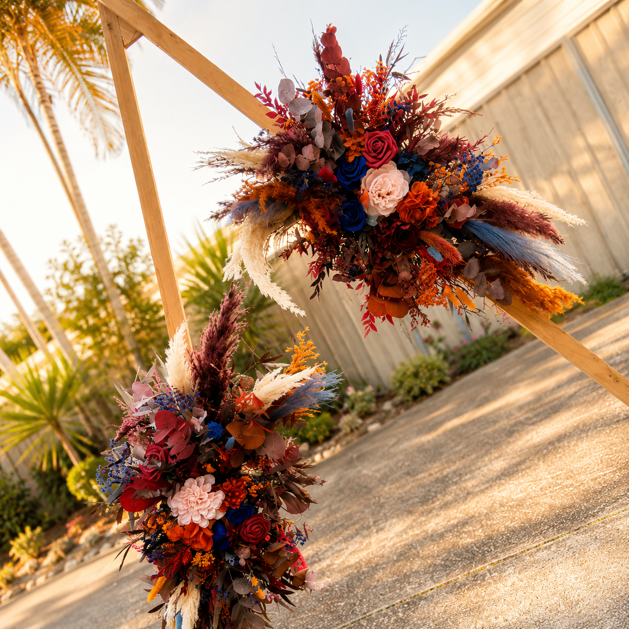 Burgundy, terracotta and navy blue dried wedding arch arrangements for boho and rustic weddings