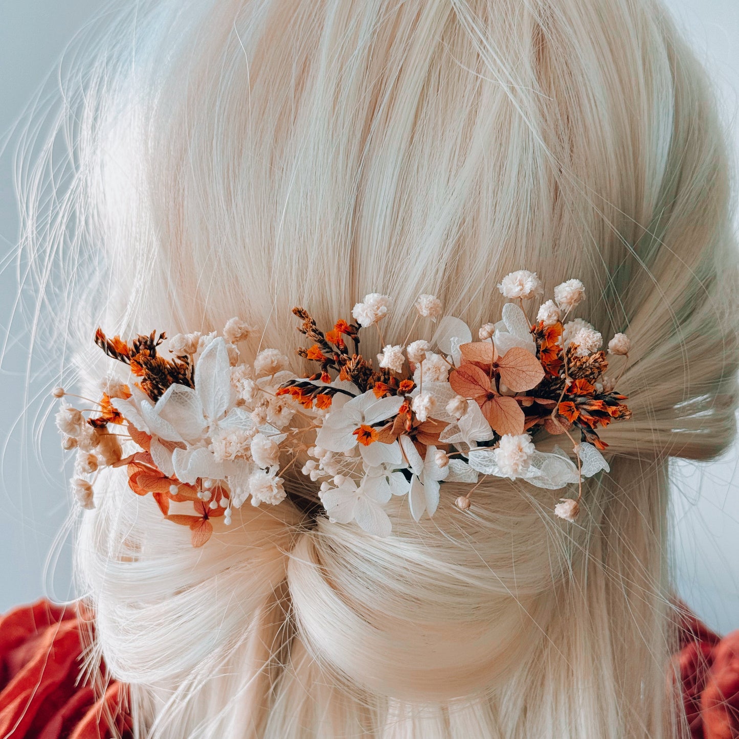 Burnt orange dried flower bridal hairpiece with preserved blooms and babyâ€™s breath, styled on blonde hair for Australian boho weddings.