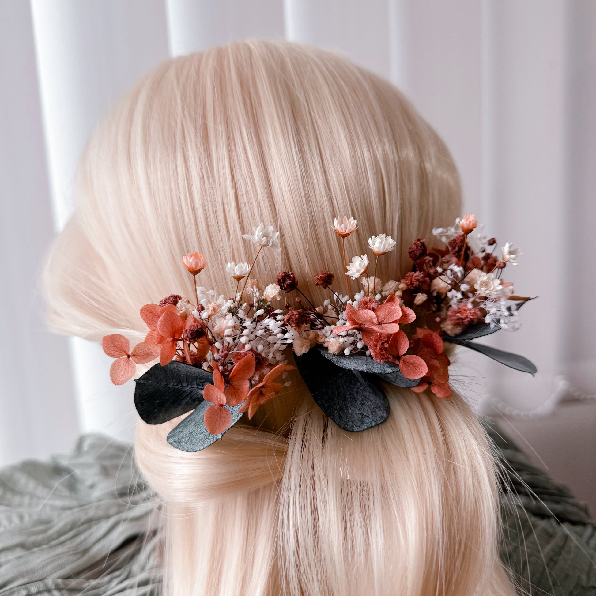 Close-up left view of a burnt orange dried flower bridal hairpiece with preserved blooms and eucalyptus, perfect for Australian boho wedding hairstyles.