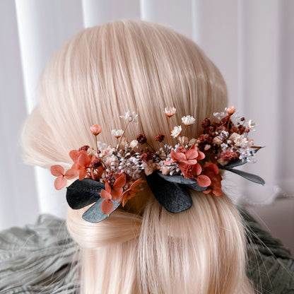 Close-up left view of a burnt orange dried flower bridal hairpiece with preserved blooms and eucalyptus, perfect for Australian boho wedding hairstyles.