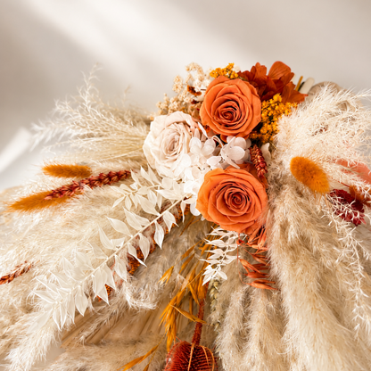 Close-up of burnt orange and ivory dried flower bouquet