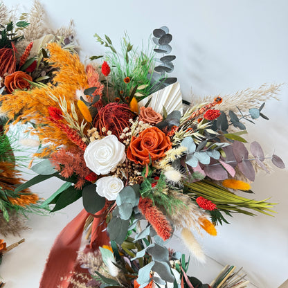 Wildflower-style dried bridal bouquet in burnt orange, rust and ivory tones with eucalyptus and preserved florals