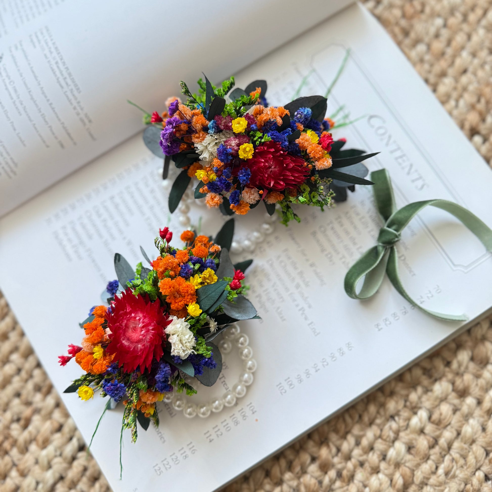 Colorful dried flower wrist corsage in wildflower style with red, orange, and purple blooms on elastic pearl band, handmade in Australia