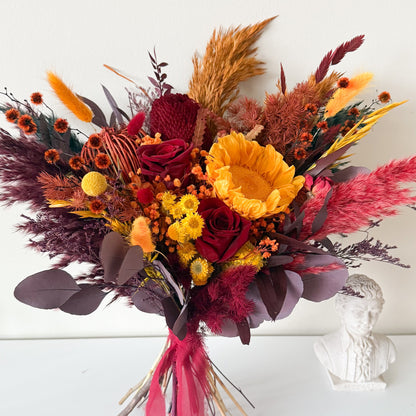 Autumn burgundy dried bridal bouquet with natural grasses and preserved flowers