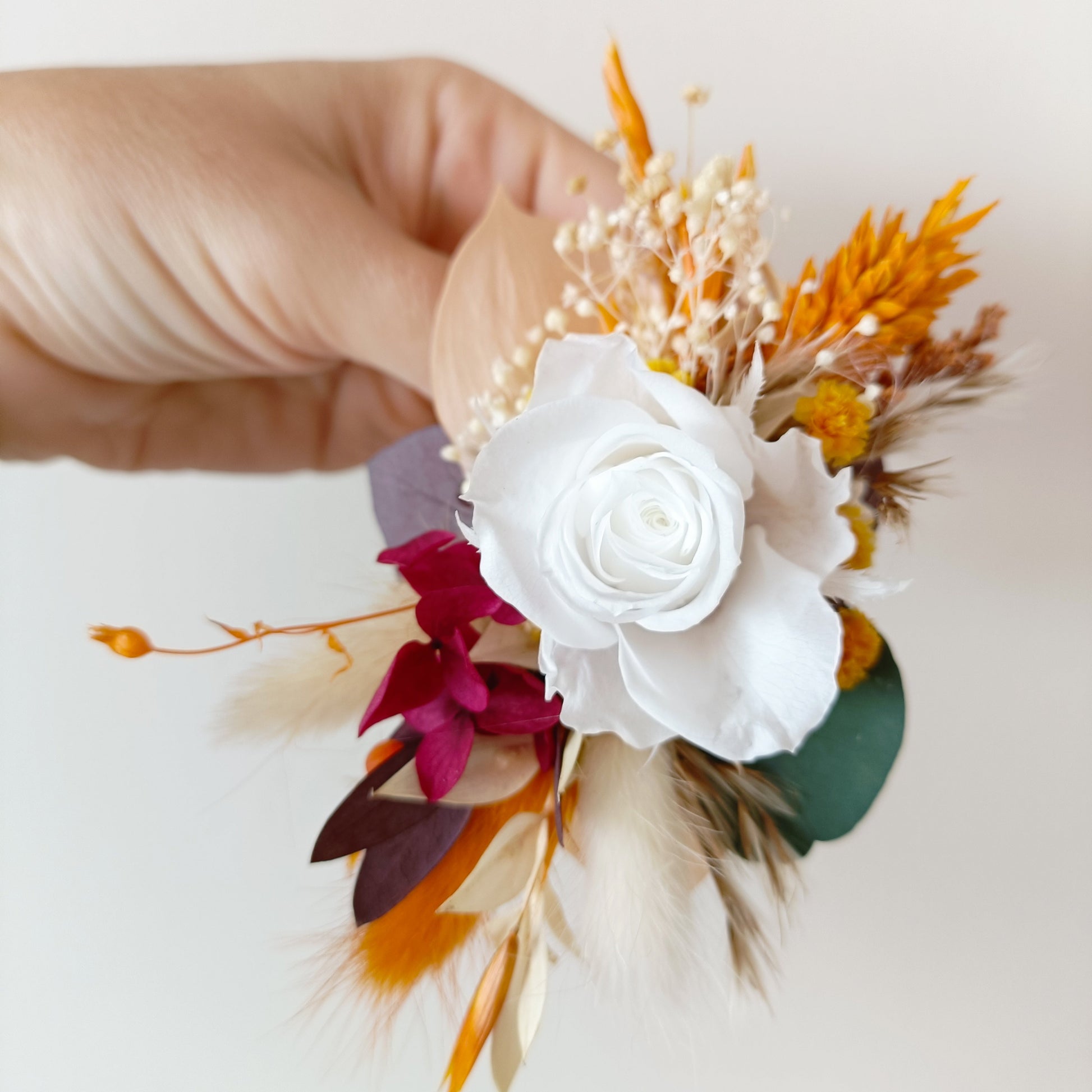 Flatlay of floral wrist corsage in box, perfect for bridesmaids or formal events